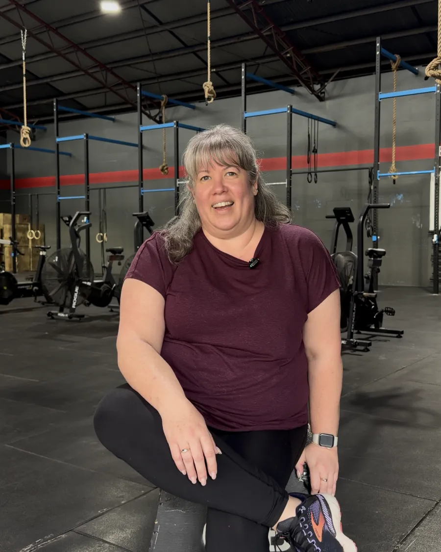 Kym, a CrossFit Brisbane member, sitting inside the gym