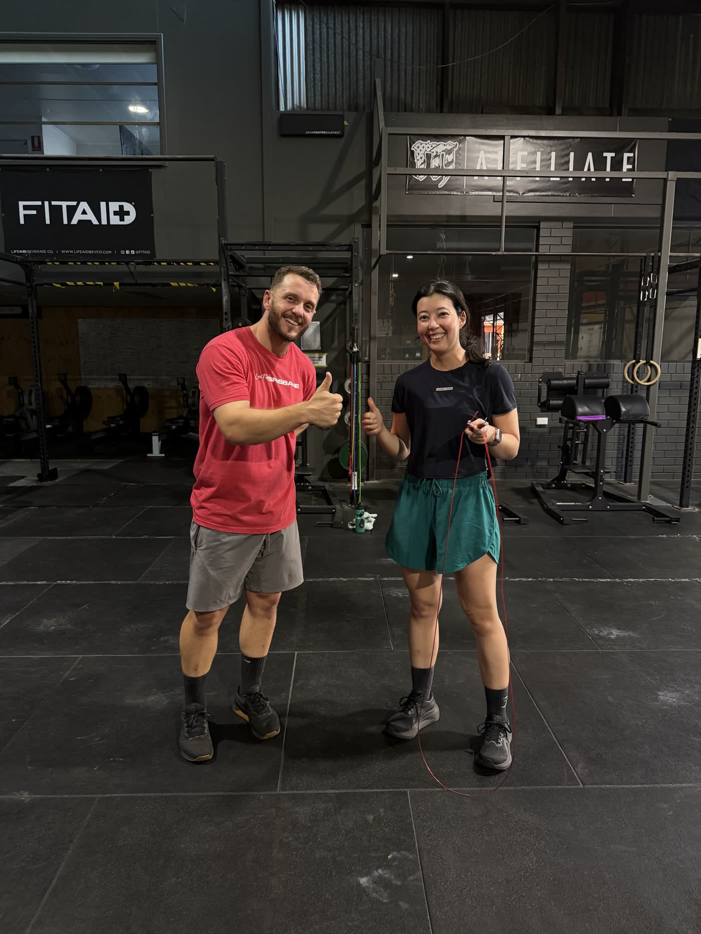 CrossFit Brisbane coach and member celebrating after personal training
